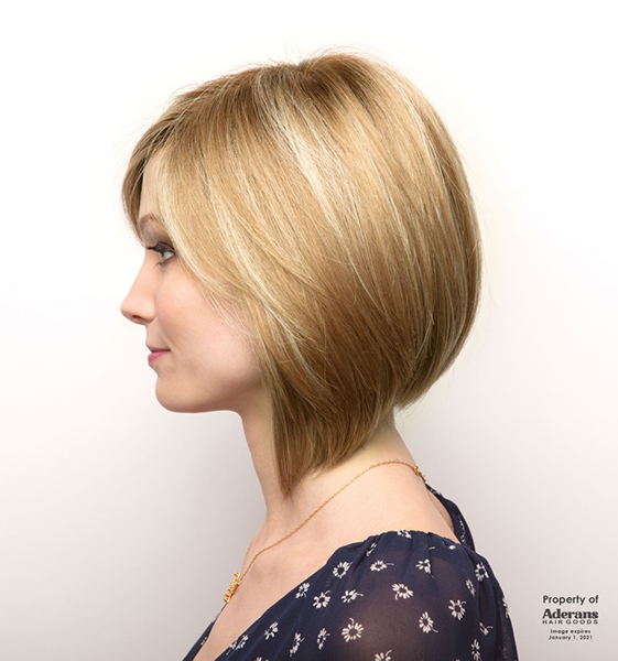 A woman wearing a short blonde wig
