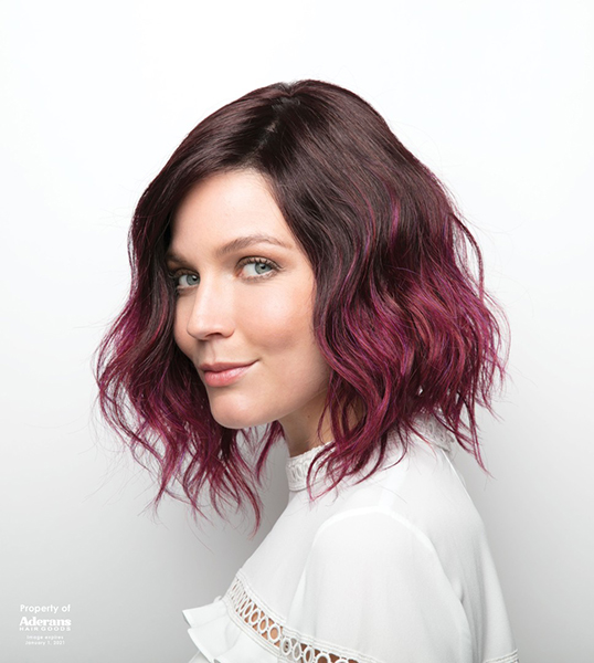 A woman wearing a black and purple ombre wig
