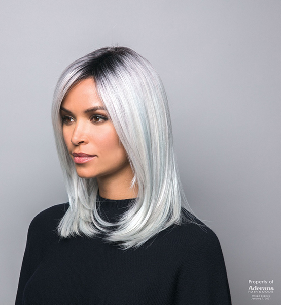 A woman wearing a mid-length platinum blonde wig
